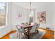 Bright dining room featuring a stylish chandelier, modern furniture, and natural light at 1741 N Emerson St, Denver, CO 80218