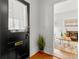 Entryway featuring a black door with white trim and a glimpse into the living room at 1741 N Emerson St, Denver, CO 80218