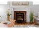 Close-up of a charming fireplace featuring decorative tiles and mantle at 1741 N Emerson St, Denver, CO 80218