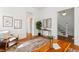 Hallway featuring hardwood floors, bright white walls, and access to other rooms at 1741 N Emerson St, Denver, CO 80218