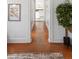 Hallway featuring hardwood floors, bright white walls, and access to other rooms at 1741 N Emerson St, Denver, CO 80218