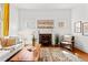 Bright living room with a cozy fireplace, hardwood floors, and stylish decor at 1741 N Emerson St, Denver, CO 80218