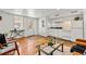 Cozy living room with hardwood flooring, white walls, and a vintage-inspired glass coffee table at 1741 N Emerson St, Denver, CO 80218