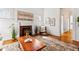 Bright living room with a cozy fireplace, hardwood floors, and stylish decor at 1741 N Emerson St, Denver, CO 80218