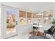 Cozy sunroom with white floors, large windows, and a breakfast nook at 1741 N Emerson St, Denver, CO 80218