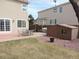 Spacious backyard with patio, ideal for outdoor gatherings and recreation with a storage shed at 21024 E 49Th Ave, Denver, CO 80249