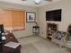 Bedroom featuring a desk, TV, and a seating area with a view from the window with horizontal blinds at 21024 E 49Th Ave, Denver, CO 80249