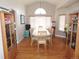 Formal dining room boasts a large window, hardwood floors, and classic wooden furniture at 21024 E 49Th Ave, Denver, CO 80249