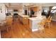 Bright kitchen features stainless appliances, a kitchen island with seating, and an adjacent dining area at 21024 E 49Th Ave, Denver, CO 80249