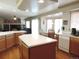 Bright kitchen featuring an island with white countertop, wood cabinets and hardwood flooring at 21024 E 49Th Ave, Denver, CO 80249