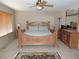 This grand main bedroom features natural light and wood furniture at 21024 E 49Th Ave, Denver, CO 80249