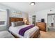 Bright bedroom with wooden bed frame and purple blanket at 881 Salem St, Aurora, CO 80011