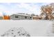 Full-view of house exterior and snow-covered yard, showcasing a newly painted home at 881 Salem St, Aurora, CO 80011