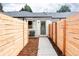 Private backyard features a newly built fence, a well-manicured walkway, and low maintenance landscaping at 4023 E Martin Luther King Jr, Denver, CO 80207