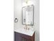 A sleek bathroom vanity with a modern sink, a black-framed mirror, and a brass faucet at 4023 E Martin Luther King Jr, Denver, CO 80207