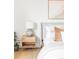 Bright bedroom features a large bed, matching nightstand, modern decor, and natural light at 4023 E Martin Luther King Jr, Denver, CO 80207
