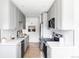 Modern kitchen featuring stainless steel appliances, gray cabinets, and white countertops at 4023 E Martin Luther King Jr, Denver, CO 80207