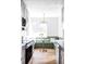 Bright eat-in kitchen features a built-in bench with a round table, plus modern finishes and natural light at 4023 E Martin Luther King Jr, Denver, CO 80207