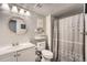 Charming bathroom with modern vanity, round mirror, and stylish shower curtain at 14602 E 2Nd Ave # 110C, Aurora, CO 80011