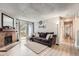 Cozy living room with a brick fireplace, comfortable seating, and natural light from the sliding glass door at 14602 E 2Nd Ave # 110C, Aurora, CO 80011