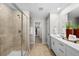 Contemporary bathroom with a glass-enclosed shower and a double vanity with white cabinets at 6570 Parterre N Pkwy # 1, Thornton, CO 80602
