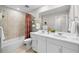 Bright bathroom featuring double sinks, a shower over tub and a neutral color palette at 6570 Parterre N Pkwy # 1, Thornton, CO 80602