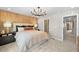 Beautiful bedroom with a view into the bathroom and wood accent wall at 6570 Parterre N Pkwy # 1, Thornton, CO 80602