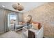 Bedroom featuring two cribs, patterned wallpaper, and a window with a view at 6570 Parterre N Pkwy # 1, Thornton, CO 80602