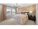 Inviting bedroom with a large window, modern lighting, and an upholstered headboard at 6570 Parterre N Pkwy # 1, Thornton, CO 80602
