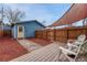 Cozy backyard features a wood fence, patio with chairs, and a unique stone walkway at 132 W Bayaud Ave, Denver, CO 80223