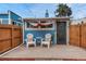 Inviting backyard with wooden deck, chairs, privacy fence, and stylish shade covering at 132 W Bayaud Ave, Denver, CO 80223