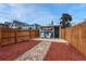 Spacious backyard with a wood fence, stone pathway, and a charming outdoor seating area at 132 W Bayaud Ave, Denver, CO 80223