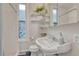 Stylish bathroom features patterned tile floor and floating shelves at 132 W Bayaud Ave, Denver, CO 80223