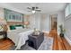 Cozy bedroom with ceiling fan, hardwood floors, and bright natural light at 132 W Bayaud Ave, Denver, CO 80223