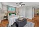 Charming bedroom features a ceiling fan, stylish decor, and hardwood floors at 132 W Bayaud Ave, Denver, CO 80223