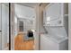 Bedroom features a stackable washer and dryer, hardwood floors, and an exit to the outside at 132 W Bayaud Ave, Denver, CO 80223
