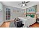 Bright bedroom with multiple windows, hardwood floors, and stylish accents at 132 W Bayaud Ave, Denver, CO 80223