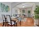 Dining area with hardwood floors, views into the living room, and stylish decor at 132 W Bayaud Ave, Denver, CO 80223