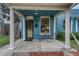 Charming blue home with a cozy front porch, complete with seating and a welcoming entrance at 132 W Bayaud Ave, Denver, CO 80223