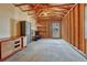 Unfinished garage featuring exposed framing, shelving, and a utility door at 132 W Bayaud Ave, Denver, CO 80223