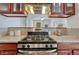 Close-up of the kitchen range featuring stainless steel appliances and granite countertops at 132 W Bayaud Ave, Denver, CO 80223