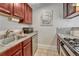 Galley kitchen features stainless steel appliances and granite countertops at 132 W Bayaud Ave, Denver, CO 80223