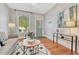 Cozy living room boasts hardwood floors, a decorative rug, and a bright window with natural light at 132 W Bayaud Ave, Denver, CO 80223