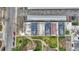 A high aerial view shows the condo roofs, community lawn with sidewalks, street parking, and nearby commercial buildings at 364 S Ironton St # 425, Aurora, CO 80012