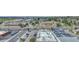 A high view shows roof tops near a busy intersection, buildings, parking lots and nearby neighborhoods at 364 S Ironton St # 425, Aurora, CO 80012