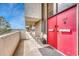 Condo balcony with a red door, seating, and mountain views, offering a private outdoor space at 364 S Ironton St # 425, Aurora, CO 80012