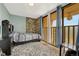 Modest bedroom features sliding glass doors to private balcony and rustic stacked-stone accent wall at 364 S Ironton St # 425, Aurora, CO 80012