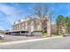 Well-maintained building exterior with covered parking and mature trees, offering curb appeal and practicality at 364 S Ironton St # 425, Aurora, CO 80012