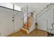 Inviting entryway with wooden stairs, white railings, and a stylish welcome mat, creating a warm greeting at 364 S Ironton St # 425, Aurora, CO 80012