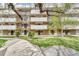 Spacious condo building with balconies, green lawn, and mature trees, offering a serene outdoor setting at 364 S Ironton St # 425, Aurora, CO 80012